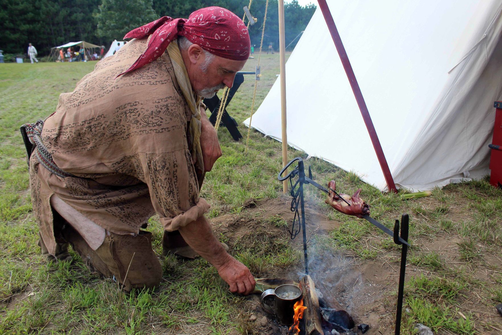 Jim cooks over fire